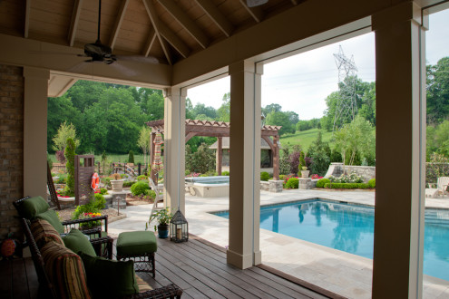 screened porch off guest house overlooking pool