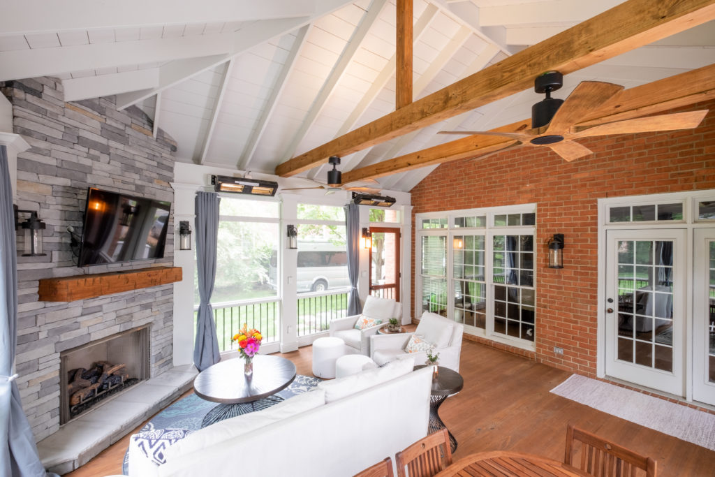 porch-screened-interior-stone-fireplace-mantel-hand-hewn-heaters-exposed-ceiling-cypress-fan