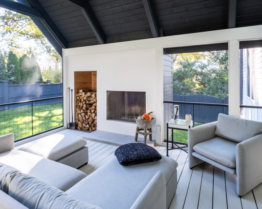 porch-screened-interior-details-aluminum-railing-fireplace-wood-fall-black-gable-roof-modern