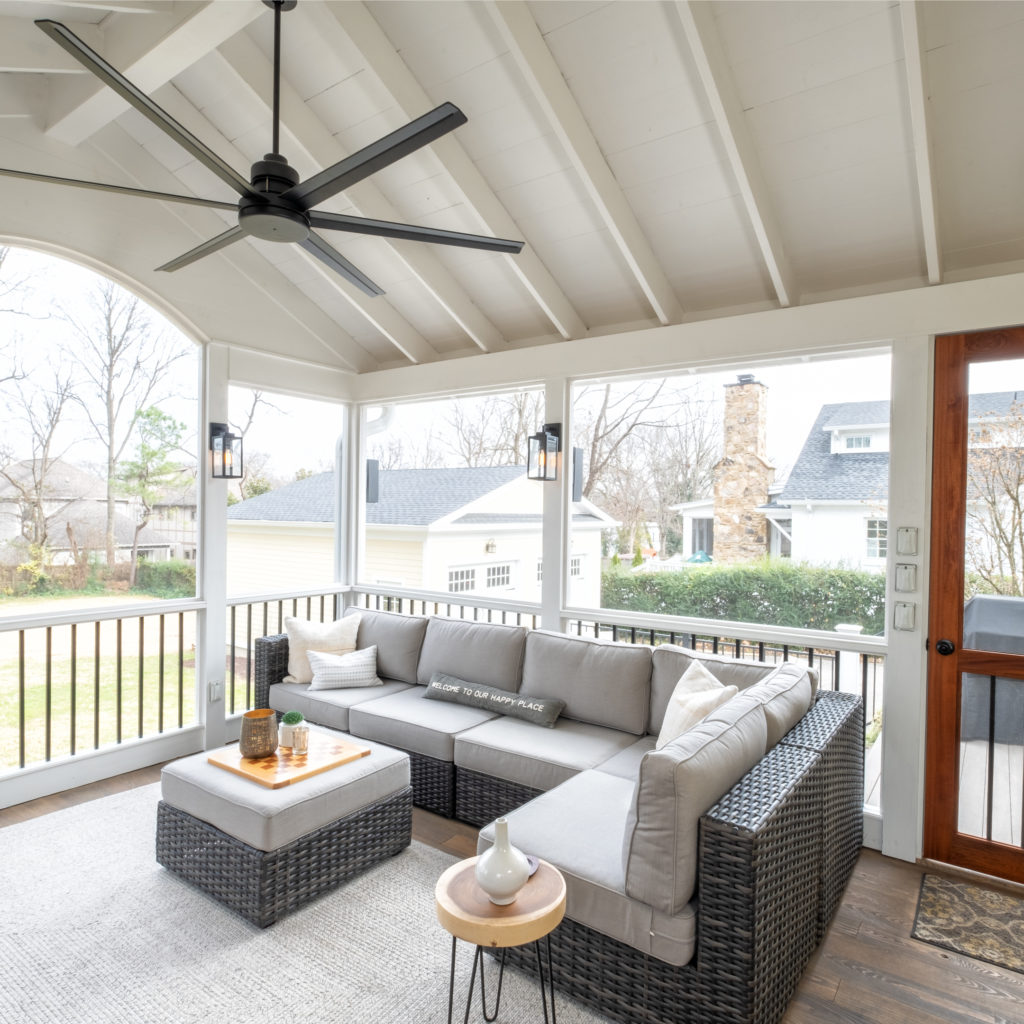 porch-screened-interior-seating-aluminum-spindle-railing-fan-exposed-ceiling