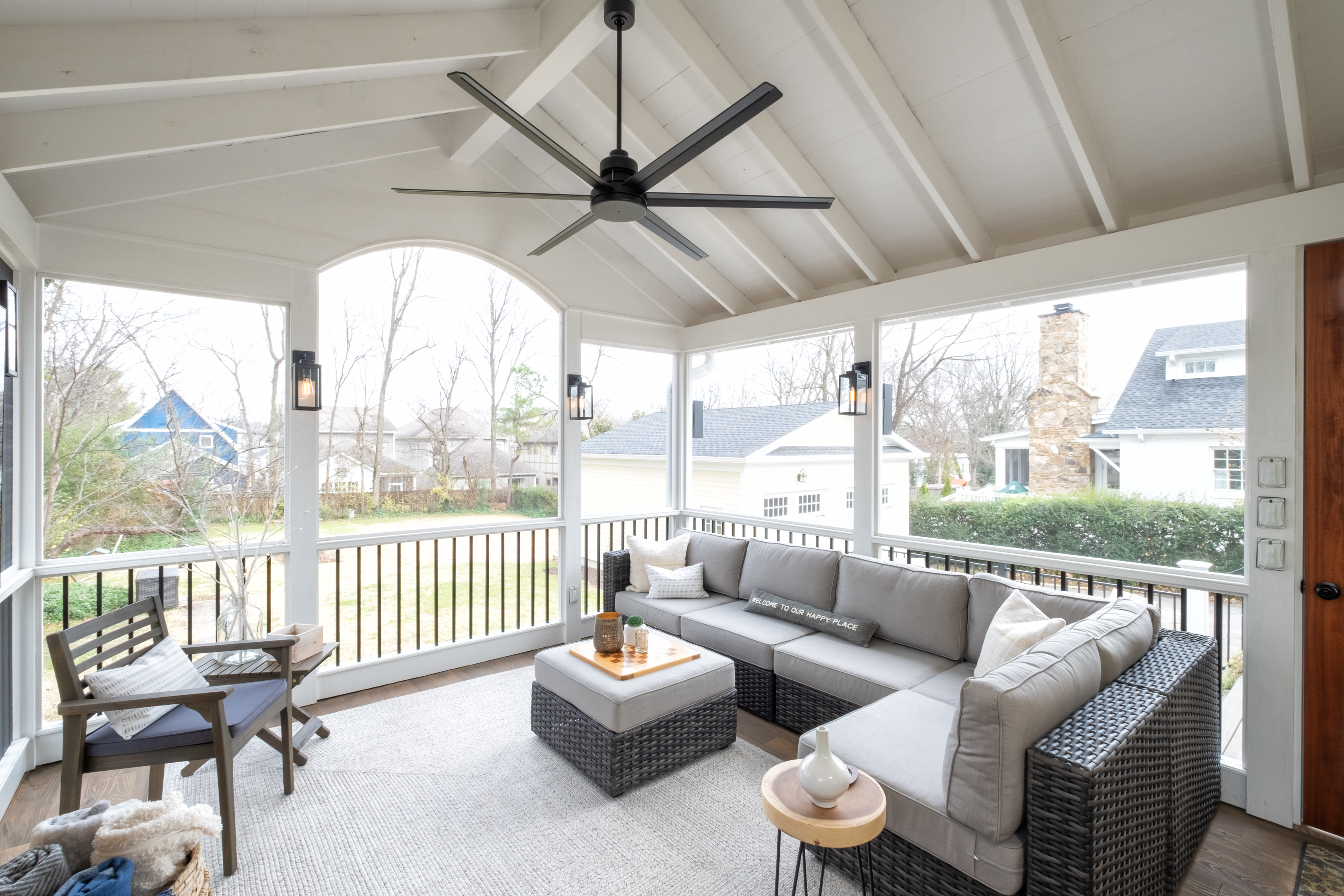 porch-screened-interior-seating-aluminum-spindle-railing-fan-exposed-ceiling