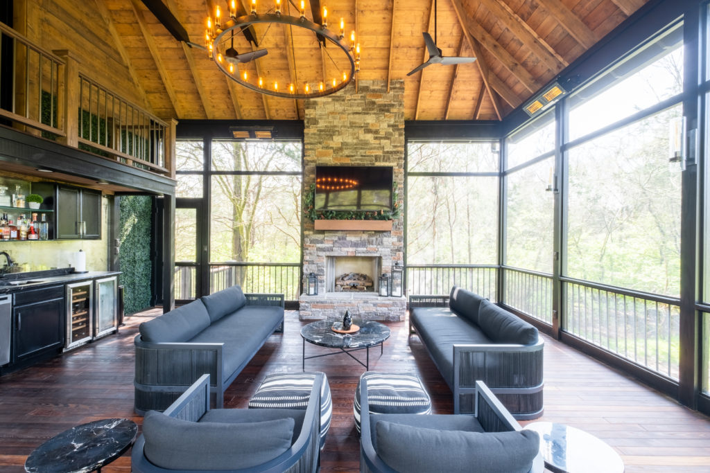 porch-screened-interior-decor-light-fixtures-spindle-wall-fireplace